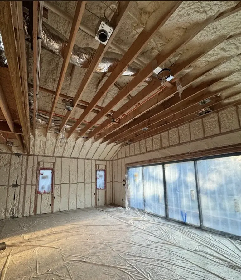 Interior walls and ceiling insulated with spray foam during new construction in Buda